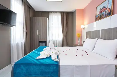 a hotel room with a large bed with flowers on it at Renzo Hotel - Special Category in Istanbul