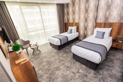a hotel room with two beds and a window at Istanbul Airport Express Hotel in Arnavutköy