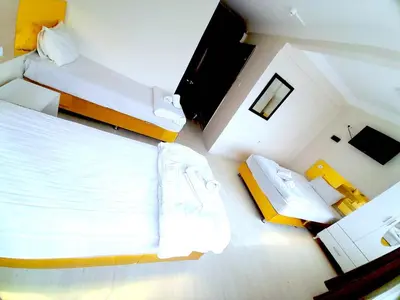 a small room with two beds and a television at Ozbekler Hotel-Old City in Istanbul