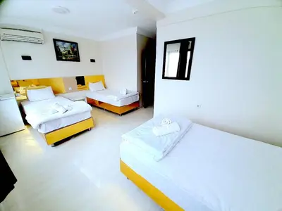 a hotel room with two beds and a room with two beds at Ozbekler Hotel-Old City in Istanbul
