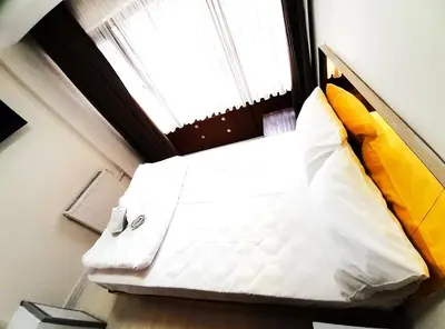 a bed in a small room with a window at Ozbekler Hotel-Old City in Istanbul