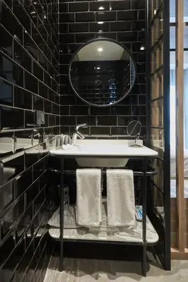 a bathroom with a sink and a mirror at Avantgarde Urban Sisli in Istanbul