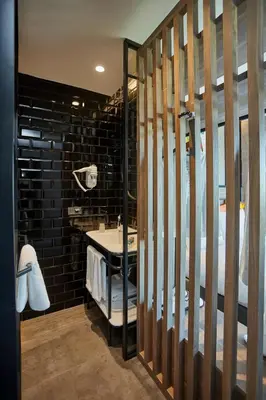 a bathroom with a sink and a bed in a room at Avantgarde Urban Sisli in Istanbul