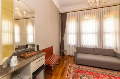 a living room with a couch and a mirror at Blue Gilroy Hotel in Istanbul