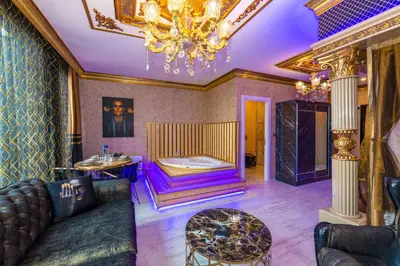 a living room with a couch and a chandelier at Istanbul Taksim Residence Hotel By MESUT in Istanbul