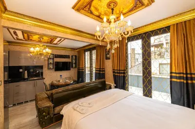 a bedroom with a bed and a chandelier at Istanbul Taksim Residence Hotel By MESUT in Istanbul