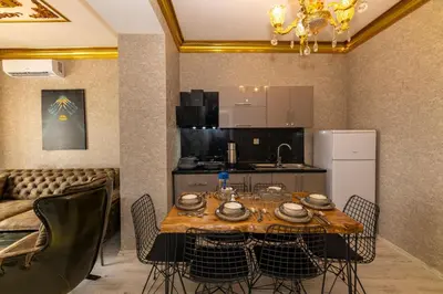 a kitchen and dining room with a table and chairs at Istanbul Taksim Residence Hotel By MESUT in Istanbul