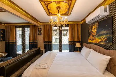 a bedroom with a large bed and a chandelier at Istanbul Taksim Residence Hotel By MESUT in Istanbul
