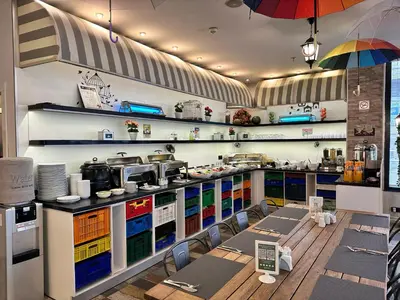 a restaurant with tables and chairs in a kitchen at Tempo Suites Airport in Istanbul