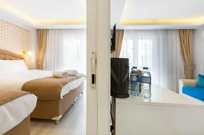 a hotel room with a bed and two bottles of water at BLUE MARMARA SUITES in Istanbul