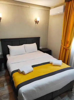 a bedroom with a large bed with towels on it at Lebon Hotel-Special Class in Istanbul