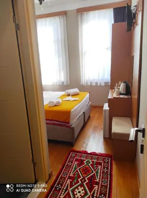 a bedroom with a bed and a red rug at Lebon Hotel-Special Class in Istanbul