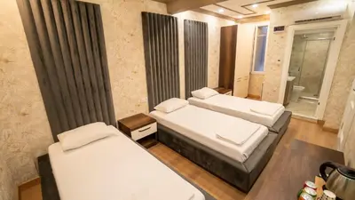 a small room with two beds and a bathroom at DYMAR HOTEL in Istanbul