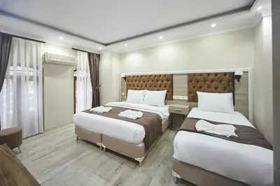 a hotel room with two beds in a room at Luna Suites Taksim in Istanbul