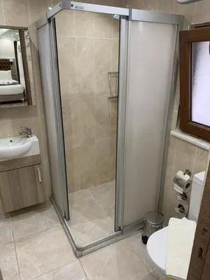 a bathroom with a shower and a toilet and a sink at Luna Suites Taksim in Istanbul