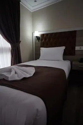 a hotel room with a large bed and a window at Luna Suites Taksim in Istanbul