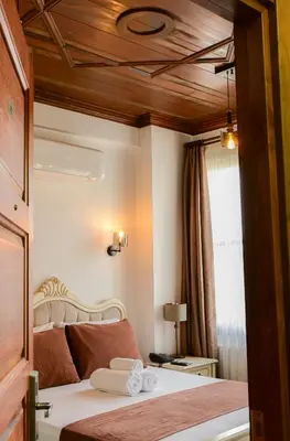 a bedroom with a bed with two towels on it at Galata Dream Hotel in Istanbul
