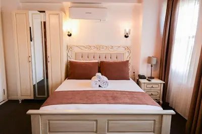 a bedroom with a large bed with two towels on it at Galata Dream Hotel in Istanbul
