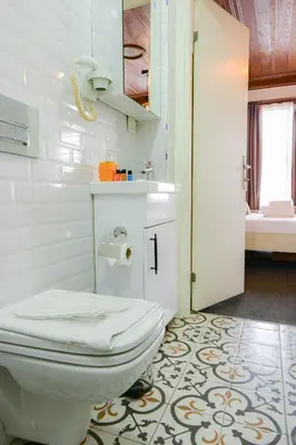 a bathroom with a toilet and a sink and a tub at Galata Dream Hotel in Istanbul