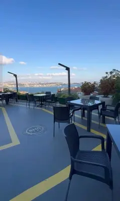 a patio with tables and chairs on a roof at Grand Star Hotel Premium in Istanbul