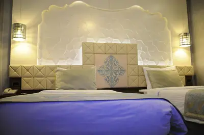 a bedroom with two beds and a large headboard at Grand Star Hotel Premium in Istanbul
