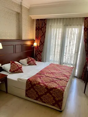 a bedroom with a large bed and a window at Istanbul Newcity Hotel in Istanbul