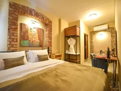 a bedroom with a large bed and a table and a desk at Maravilloso Hotel Pera in Istanbul