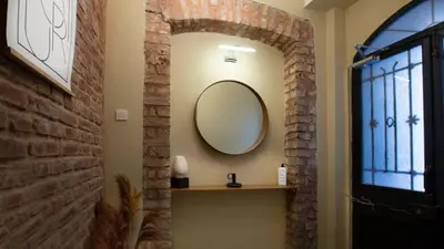 a mirror on the wall of a room with a window at Maravilloso Hotel Pera in Istanbul