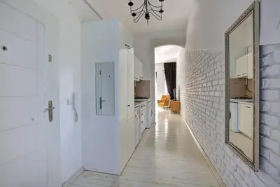 a hallway with white walls and a mirror on the wall at Maravilloso Hotel Galata in Istanbul