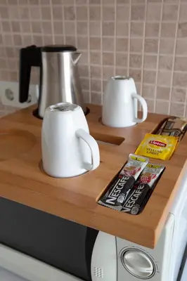 two white mugs sitting on top of a counter at Maravilloso Hotel Galata in Istanbul