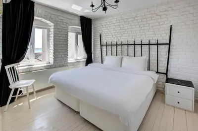 a bedroom with a large white bed and a brick wall at Maravilloso Hotel Galata in Istanbul