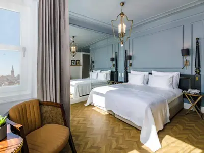 a hotel room with two beds and a chair at The Soul Istanbul Hotel in Istanbul