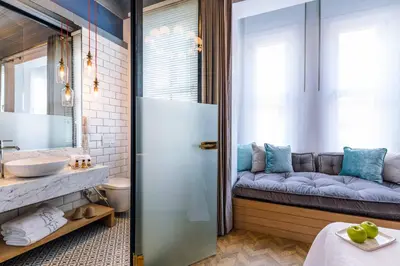 a bathroom with a couch and a sink at The Soul Istanbul Hotel in Istanbul