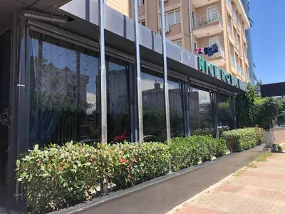 a store front of a building with windows and bushes at Nice Royal in Istanbul