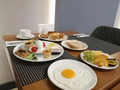 a table with plates of breakfast food on it at Kayhan City Hotel in Bursa