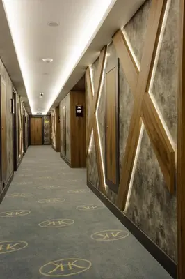 a corridor in a building with wooden walls and a hallway with at Kayhan City Hotel in Bursa