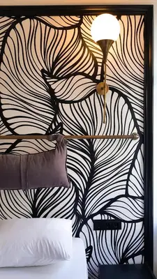 a bedroom with a black and white wall with a lamp at Casa Rosa Suites in Istanbul