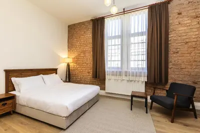 a bedroom with a bed and a desk and a chair at The Nomad Inn Old City İstanbul in Istanbul