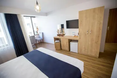 a bedroom with a bed and a desk with a television at Golden Street Hotel in Istanbul