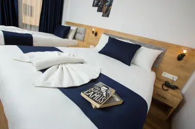 a bed with a book sitting on top of it at Golden Street Hotel in Istanbul