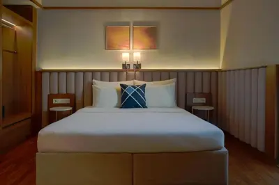 a bedroom with a large bed with two tables at Four Points Flex by Sheraton Bursa Nilüfer in Bursa