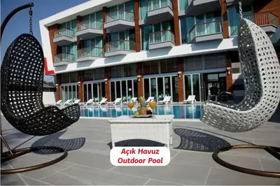 a hotel with two large metal sculptures in front of a building at Yalova Lova Hotel & SPA Yalova in Yalova