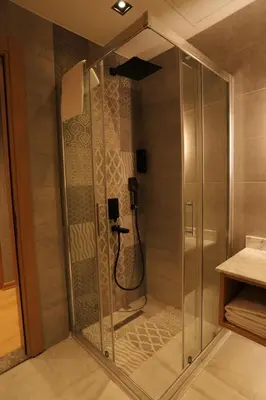 a shower stall with a phone in a bathroom at My Garden Hotel in Istanbul