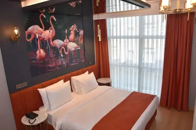 a bedroom with a bed with a painting of flamingos at My Garden Hotel in Istanbul