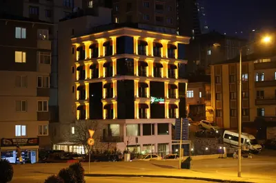 a lit up building in a city at night at My Garden Hotel in Istanbul
