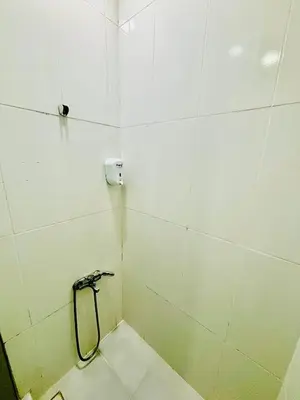 a white tiled bathroom with a shower stall at İmmortal Hotel İstanbul in Istanbul