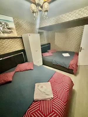 a bedroom with two beds and a chandelier at İmmortal Hotel İstanbul in Istanbul