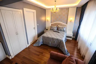 a bedroom with a bed and a couch at Thermal Saray Hotel & Yalova in Gokcedere