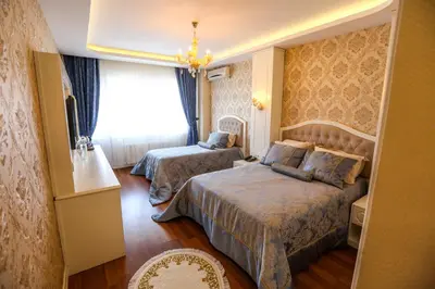 a hotel room with two beds and a window at Thermal Saray Hotel & Yalova in Gokcedere