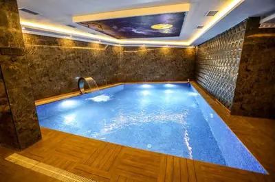 a large swimming pool in a room at Thermal Saray Hotel & Yalova in Gokcedere
